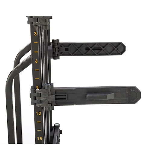 Close-up of a DEWALT photography accessory with adjustable black arms and measurement markings on a vertical metal pole.