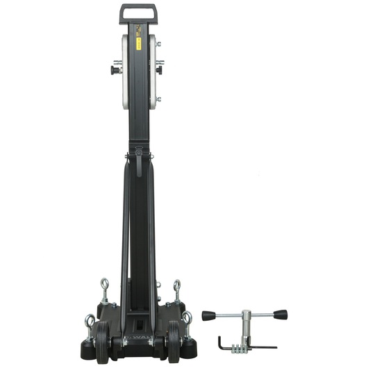 A DEWALT drill stand with a long vertical column and sturdy base, shown from the front. Beside it is a metal tool accessory with handles, placed on a white background.