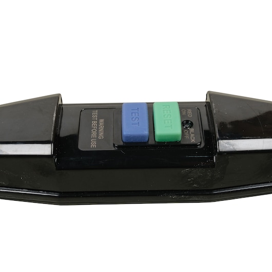 A close-up image of a black electrical device with blue and green buttons labeled 'TEST' and 'RESET'. There is also a warning to test before use and an indicator with options for 'red on' and 'black off'.