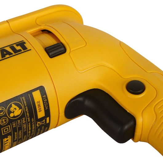Close-up view of a yellow DEWALT power tool handle, showing trigger and control buttons, along with part of the label detailing specifications.
