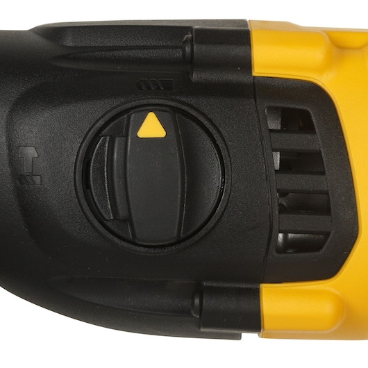 Close-up of a DEWALT power tool adjustment dial with a yellow triangle indicator, black casing, and yellow accent, showing part of the tool's vent and grip.