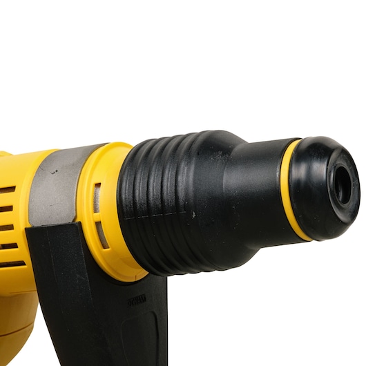 Close-up view of the front section of a yellow and black Dewalt power tool, showing the drill chuck and handle.