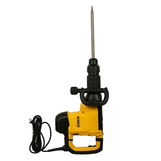 A DEWALT electric demolition hammer with a yellow and black body, side handle, and long chisel bit, shown standing upright with its power cord coiled beside it.