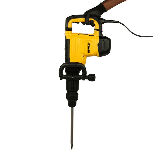 Photo of DEWALT D25893K demolition hammer, yellow and black, side angle, held by a gloved hand.