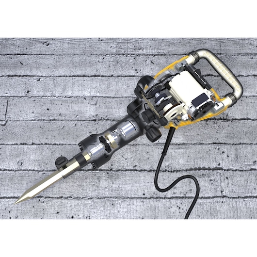 A DEWALT electric jackhammer with visible internal components, including gears and motor parts, placed on a concrete surface.