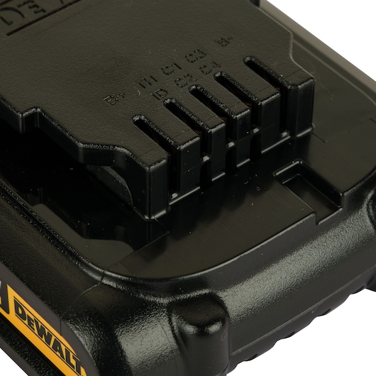 Close-up view of a DEWALT battery pack, showing the connector pins and part of the yellow and black casing.