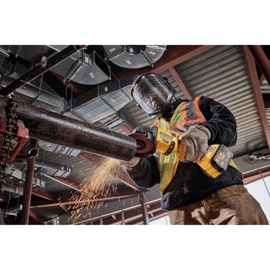 20 Volt to 60 Volt 9 AMP hours Lithium-Ion Battery-powered Polishing Tool being used by a construction worker to polish a metal rod at a construction site
