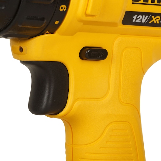 Close-up image of a yellow DEWALT 12V XR cordless drill handle, showing part of the grip, forward/reverse switch, and trigger.