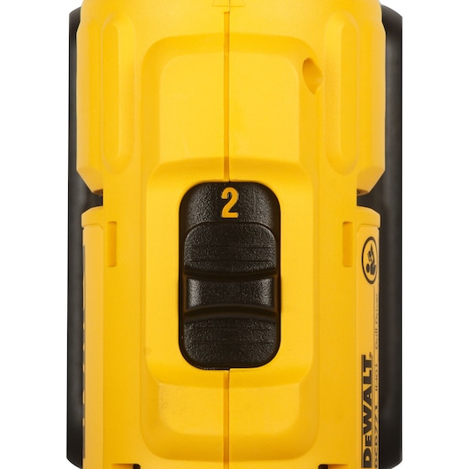 Close-up view of a yellow DEWALT DCD771S2 cordless drill showing the black speed control switch with the number 2 and part of the DEWALT branding on the side.