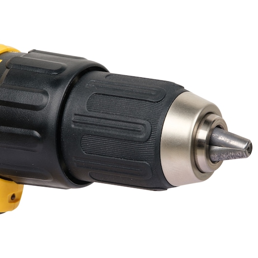 Close-up view of the chuck and drill bit of a DEWALT cordless drill, showing the black textured grip and metallic tip.