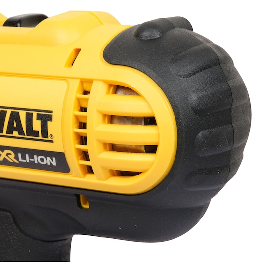 Close-up of a DEWALT cordless tool, focusing on the yellow and black body near the motor vents, with visible branding and Li-ION XR battery label.