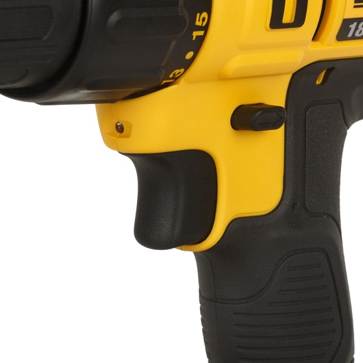 Close-up view of the handle and trigger of a yellow and black DEWALT cordless drill.