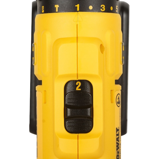 Close-up view of the control panel on a yellow DEWALT power tool, showing a black speed selector switch marked with the number 2 and a numbered dial at the top.