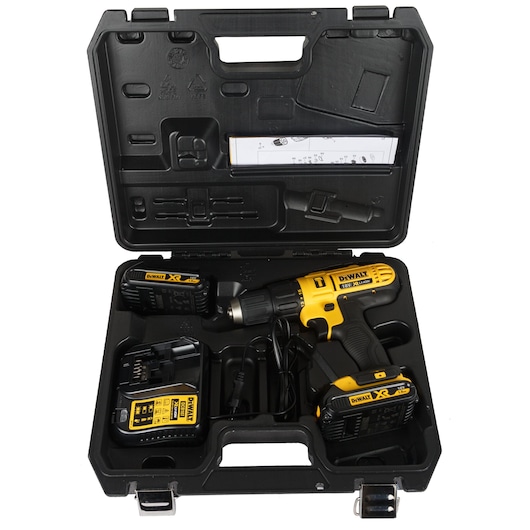 A black hard plastic carrying case containing a yellow and black DEWALT cordless drill with two battery packs, a battery charger, and a charging cable. The case also includes a user manual.