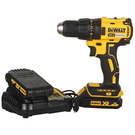 A yellow and black DEWALT cordless drill with an 18V battery and charger. The drill has a comfortable handle and is shown with the battery charging unit placed beside it.