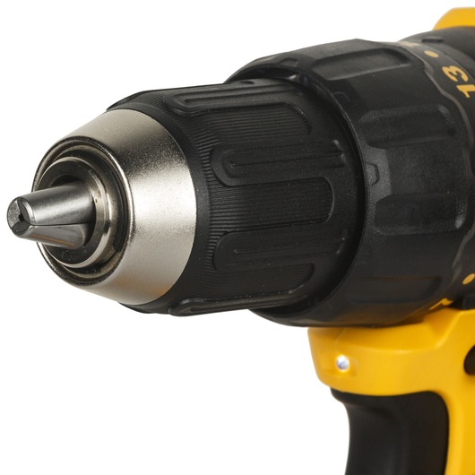 Close-up view of the front section of a DEWALT cordless drill, showing its black and silver chuck and part of the yellow and black handle.