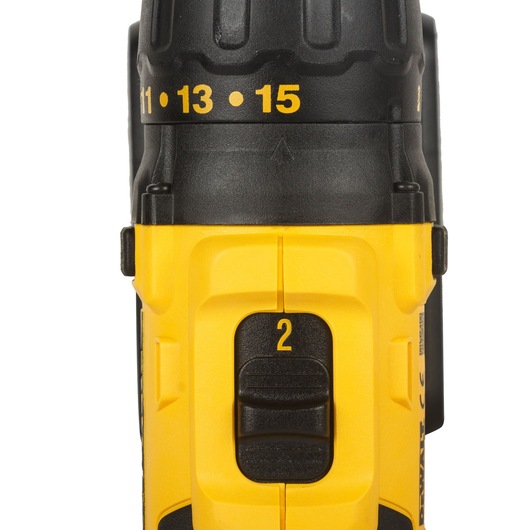 Close-up view of a yellow and black DEWALT cordless drill, showing the gear selector switch set to '2' and torque settings numbered 11, 13, and 15 on the adjustable ring.