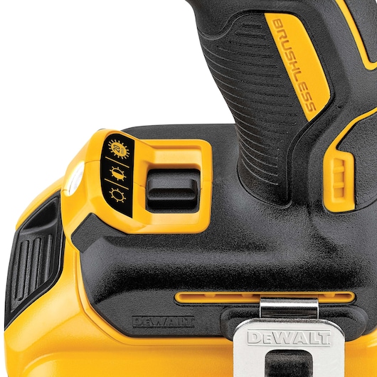 Close-up of a DEWALT cordless drill handle with brushless motor and a three-setting light control switch.