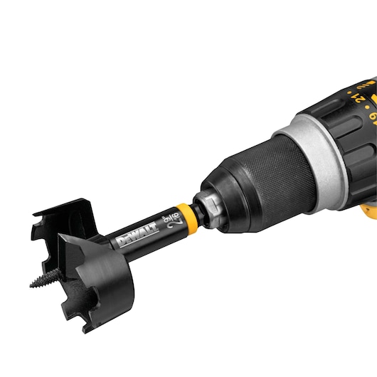 Close-up of a DEWALT cordless power drill with a hole saw attachment installed, designed for precise drilling in wood or similar materials.