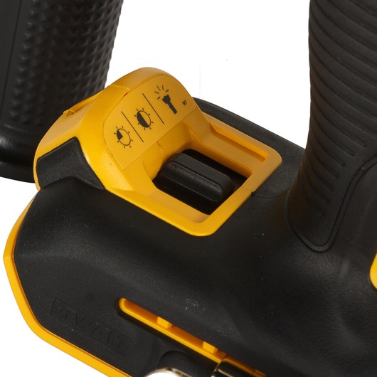 Close-up of a DEWALT power tool showing the yellow and black control button for the three-mode LED light settings.