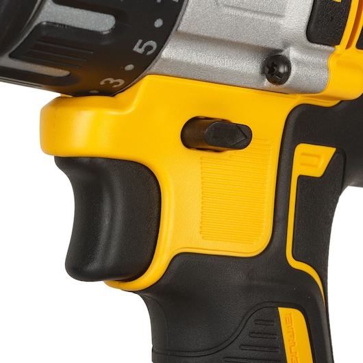 Close-up view of the handle and control switch of a DEWALT power drill, showing the yellow and black ergonomic design and part of the adjustment dial.