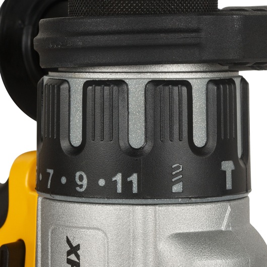 Close-up view of the torque adjustment ring and selector switch on a DEWALT cordless drill, showing numbers and symbols for different settings.