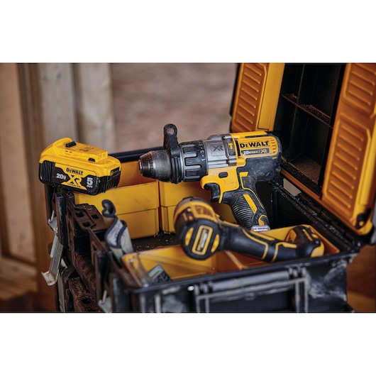 A DEWALT 20V Max XR cordless drill and battery pack in a yellow and black tool case. The drill and battery display the DEWALT branding and specifications.