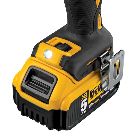 Close-up view of a DEWALT cordless power tool, showing the handle, LED light, battery pack with 5 Ah capacity, and metal belt clip.