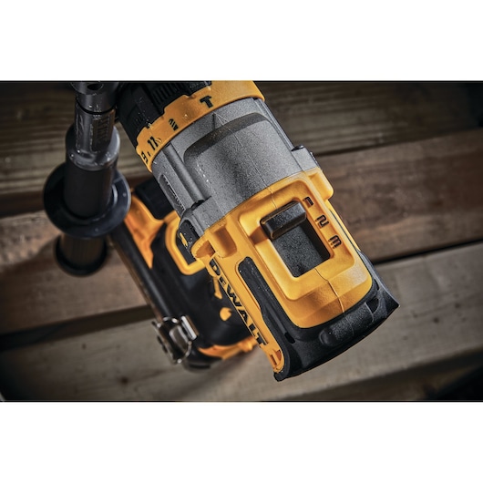 Close-up of a DEWALT cordless drill showing the handle and part of the body, featuring a yellow and black design and speed settings.