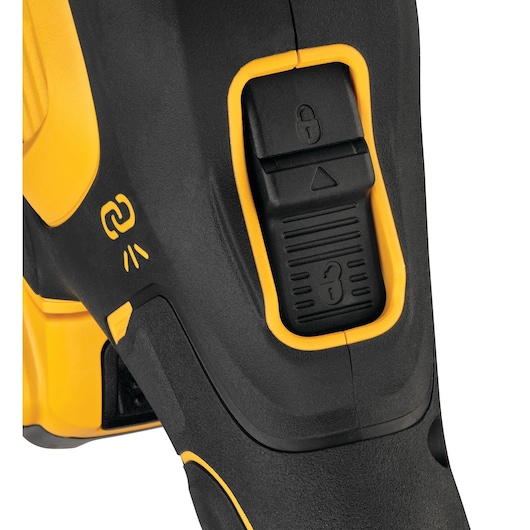 Close-up view of a DEWALT power tool handle, featuring a black and yellow lock switch and an icon indicating a connectivity or activation function.