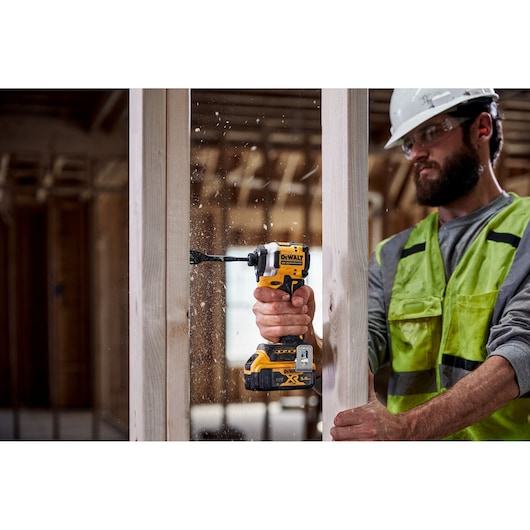 DEWALT drill used on wood. Models: DCF850N, DCZ2050P2T-XE, DCZ401P3-XE.