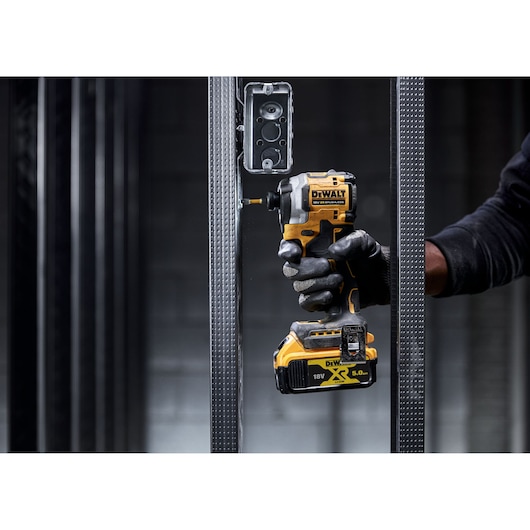 DEWALT tool in use. Shown: DCF850N, DCZ2050P2T-XE, DCZ401P3-XE. Compact cordless driver for construction jobs.