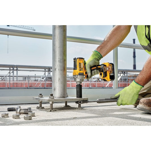 CORDLESS IMPACT WRENCH WITH DETENT PIN ANVIL being used on a work site