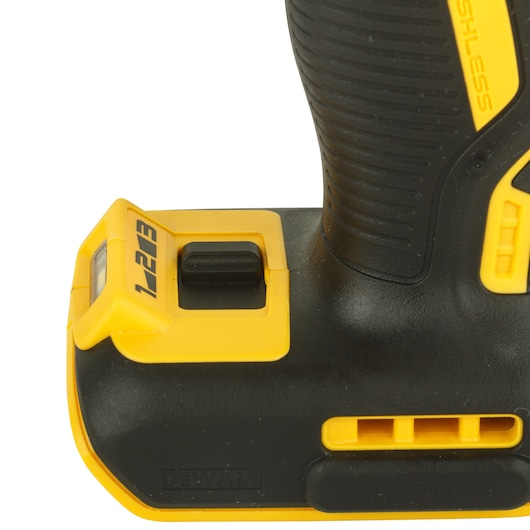 Close-up of the lower handle and control area of a DEWALT power tool showing the speed settings switch labeled 1, 2, 3. The tool is black and yellow with a textured grip and visible DEWALT branding.