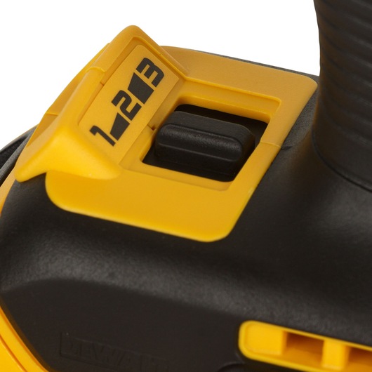 Close-up of a DEWALT power tool showing a yellow and black speed selector switch labeled with numbers 1, 2, and 3.