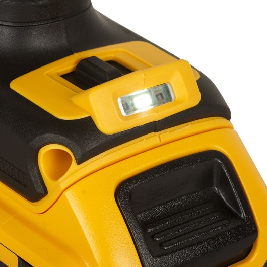 Close-up view of a DEWALT power tool showing a bright LED work light and part of a yellow and black casing.