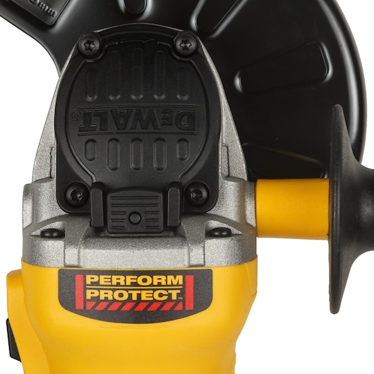Close-up view of a DEWALT Perform & Protect angle grinder with a yellow and black design. The DEWALT logo is clearly visible along with the Perform & Protect label on the body.