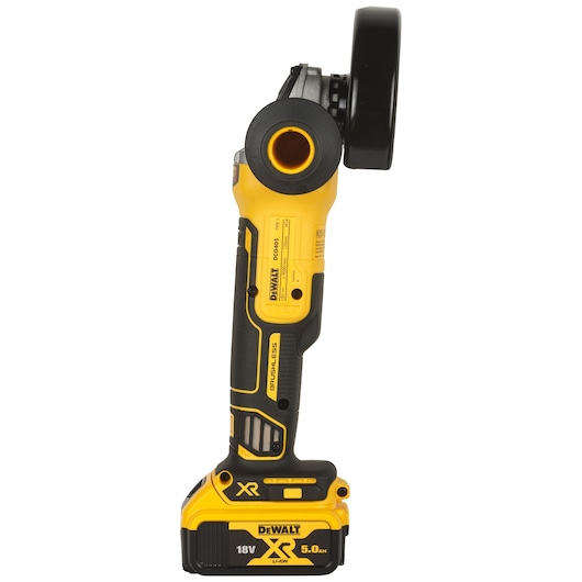 A DEWALT DCG405P2-QW 18V XR brushless cordless angle grinder with a 5.0 Ah battery, shown vertically with the grinding wheel facing right. The tool is yellow and black.
