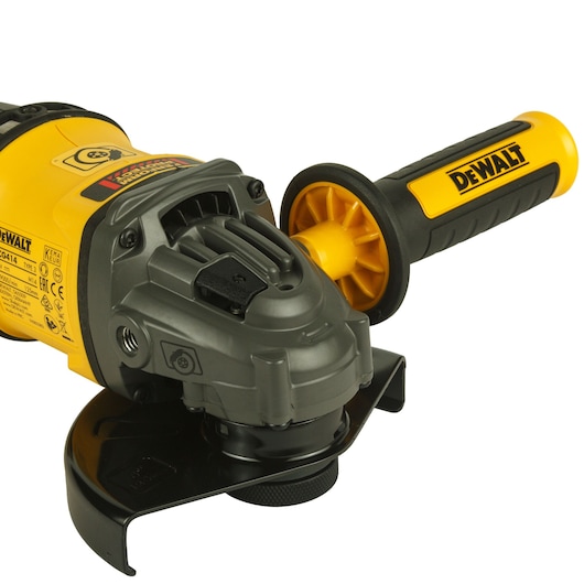 Close-up view of a DEWALT cordless angle grinder with a yellow and black handle and safety guard.
