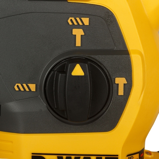 Close-up of DEWALT DCH333NT rotary tool mode selector dial with yellow symbols on black and yellow housing.