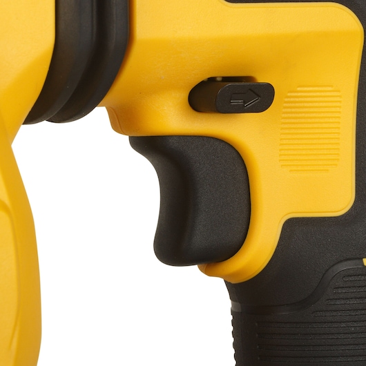 Close-up of a yellow and black DEWALT tool handle and trigger with directional switch.