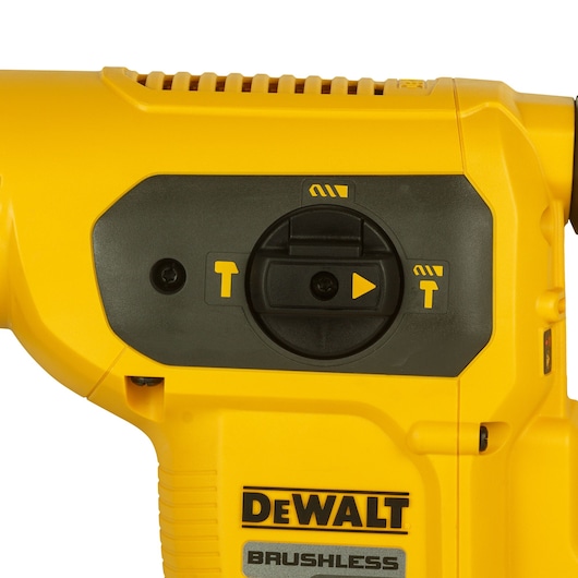 Close-up of a yellow DEWALT brushless power tool showing its mode selection dial and control panel.