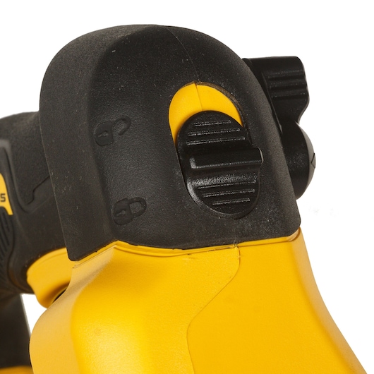 Close-up view of a DEWALT DCM572N tool, showing the black and yellow plastic housing with a textured switch and lock symbols.