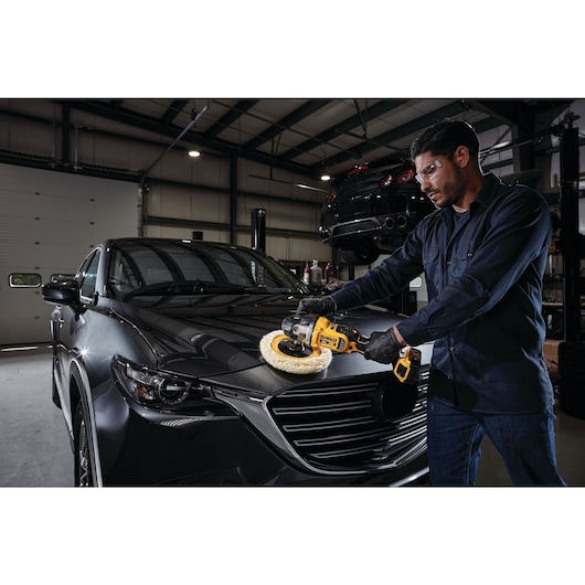 XR cordless variable speed rotary polisher being used by a person to polish a car