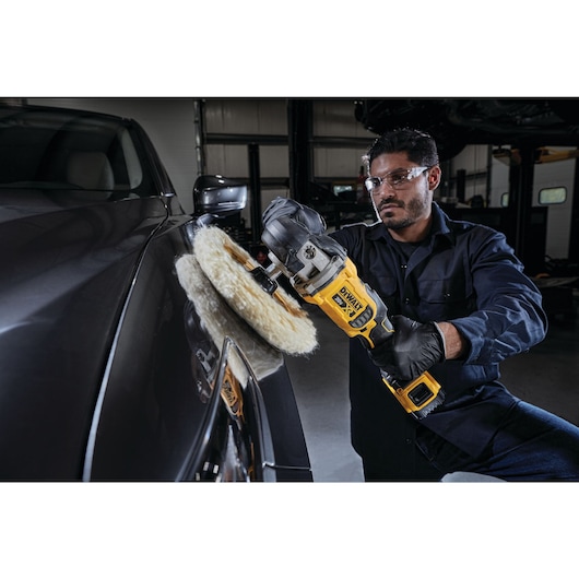 XR cordless variable speed rotary polisher being used by a person to polish a car