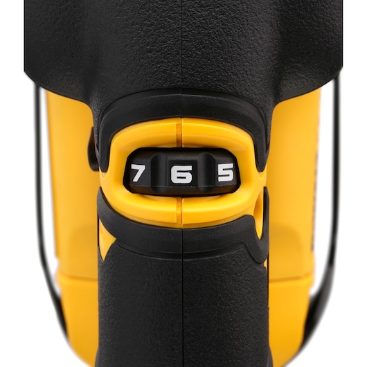 Close-up of DEWALT tool speed dial showing numbers 5, 6, and 7 on a yellow and black device.