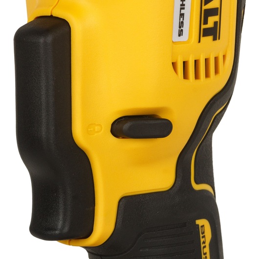 Close-up view of the side switch and handle section of a yellow and black DEWALT cordless power tool.