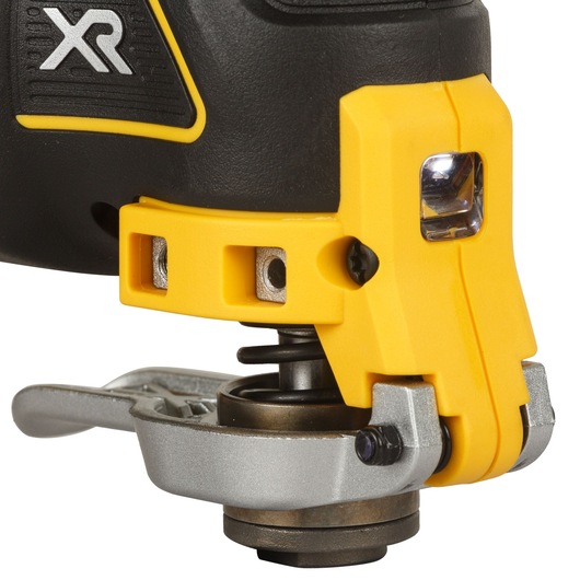 Close-up of the front section of a DEWALT DCS355D2 oscillating multi-tool, featuring a yellow and black design, a metal attachment mechanism, and a built-in LED light.
