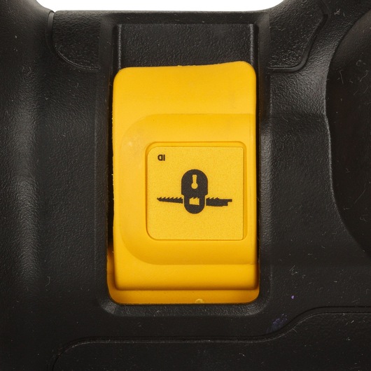 Close-up of a yellow switch on a black DEWALT power tool, showing an illustration of a saw blade and lock mechanism.