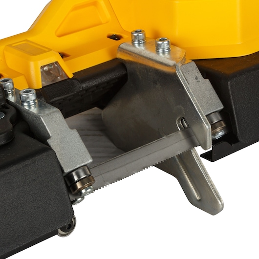 Close-up view of a DEWALT portable band saw showing the blade and metal components.